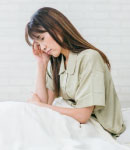 ベッドで悩んでいる女性